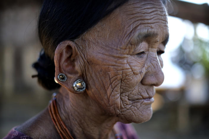 Nguntoi Konyak, 85, sits outside her home in Oting village, in the northeastern Indian state of Nagaland, Thursday, Dec. 16, 2021. "They killed innocent villagers. All the young boys of this village have been killed," Nguntoi said. High up in the hills along India's border with Myanmar, Oting village is in mourning after more than a dozen people from the village were killed by Indian army soldiers. (AP Photo/Yirmiyan Arthur)