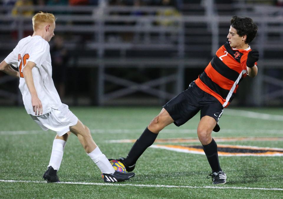 Green's Gavin Shawball (left) fights for control of the ball with Hoover's Logan Ash (right) during a game last month. Ash scored the Vikings' only goal in the Vikings' 5-1 Division I regional semifinal loss to Medina on Wednesday.