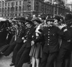 <p>A group of policeman struggle to keep the boisterous crowds back, as a mass of people ascend on Parliament Square in London. </p>