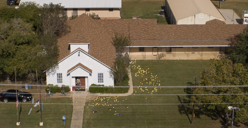 <em>Evidence flag mark the lawn of the First Baptist Church after Sunday’s mass shooting (AP)</em>