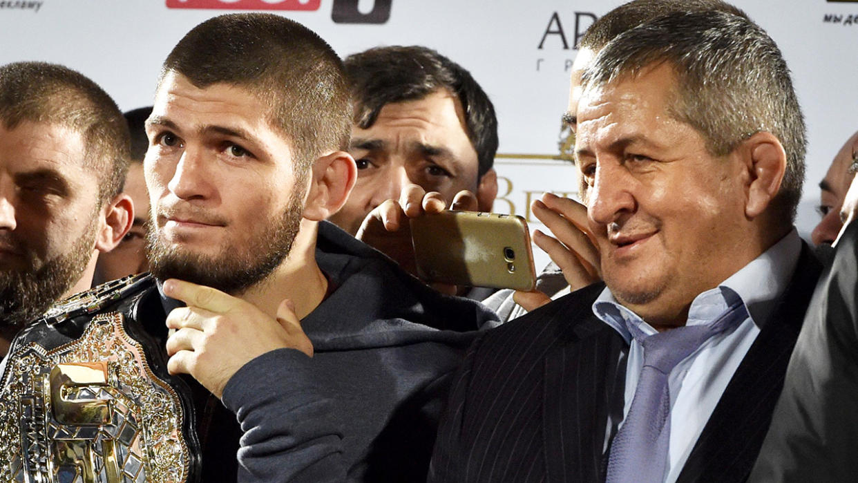 Khabib Nurmagomedov holds his champions belt next to his father Abdulmanap after his 2018 victory over rival Conor McGregor. (Photo: VASILY MAXIMOV/AFP via Getty Images)