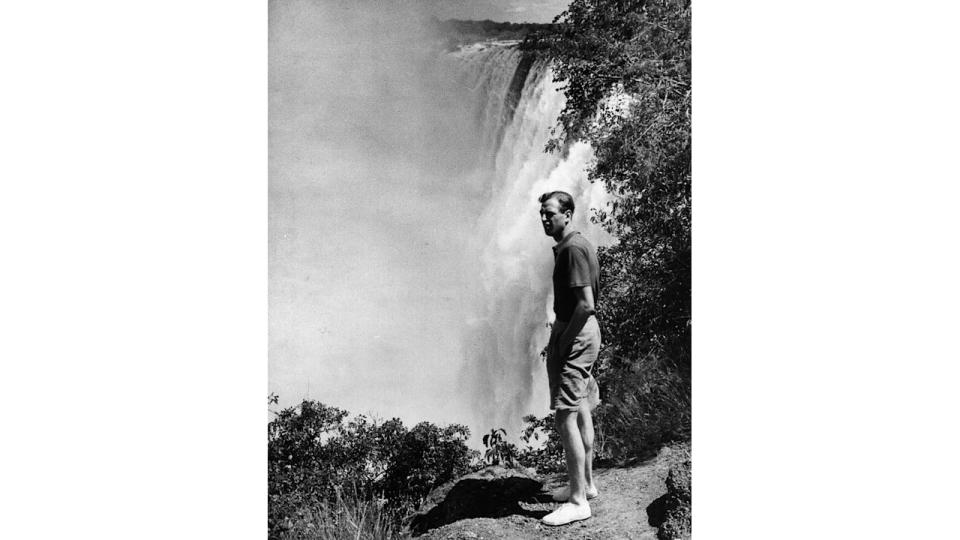 Prince George, Duke of Kent stood next to a waterfall