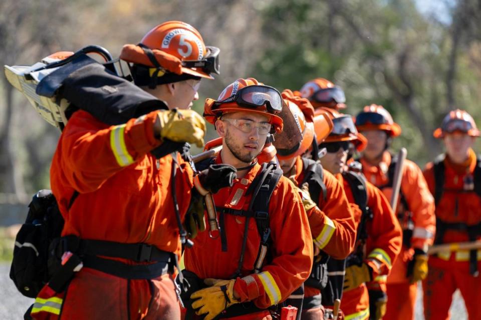 Cal Fire Inmate Michael Nguyen, second from left, lines up his Crew 5 team members as they demonstrate their skills at the Growlersburg Conservation Camp in Georgetown in March. The California Department of Corrections is piloting a new “Youth Offender Program” where inmates between under age 26 who have more severe sentences on their record are eligible for fire camps on a case-by-case basis.