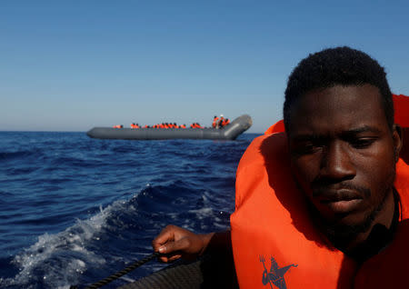 A migrant reacts after being rescued from a rubber dinghy by the Malta-based NGO Migrant Offshore Aid Station (MOAS) in the central Mediterranean in international waters some 15 nautical miles off the coast of Zawiya in Libya, April 14, 2017. REUTERS/Darrin Zammit Lupi