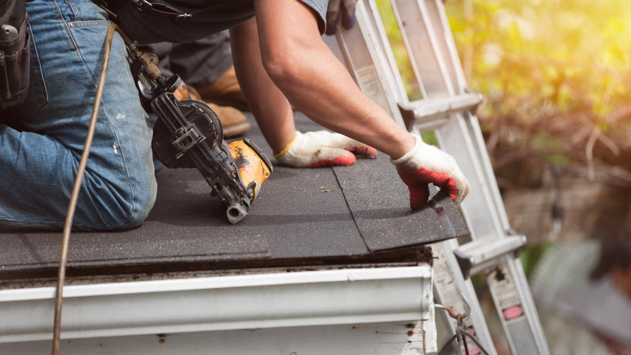 roofers installing a new roof on residential home.