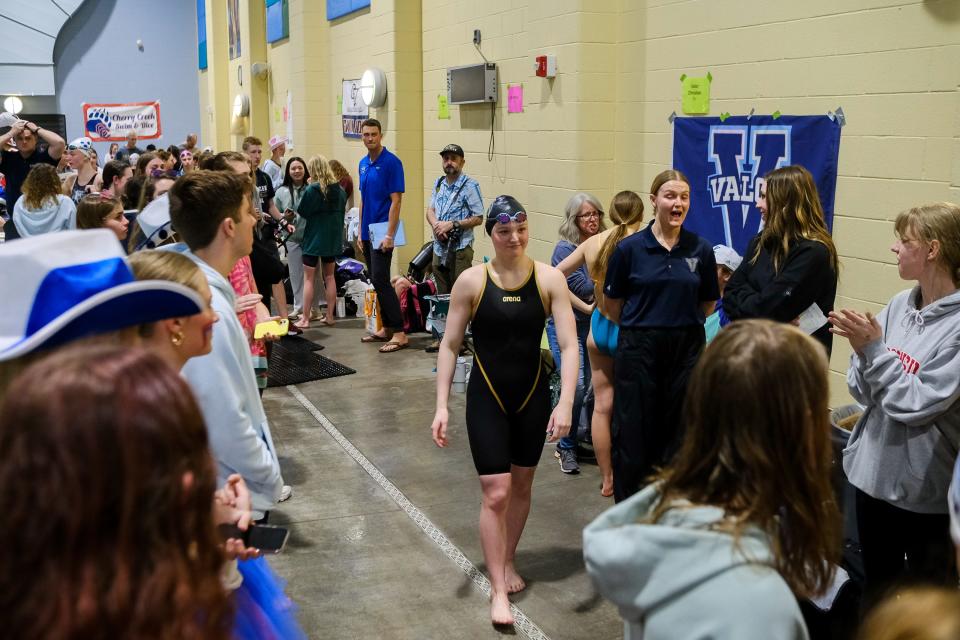 Fossil Ridge’s Ella Gaca-Thiele walks to the podium at the Colorado 5A girls swimming state championships to receive her gold medal on Friday, Feb. 9, 2024, at Veterans Memorial Aquatics Center in Thornton, Colo.