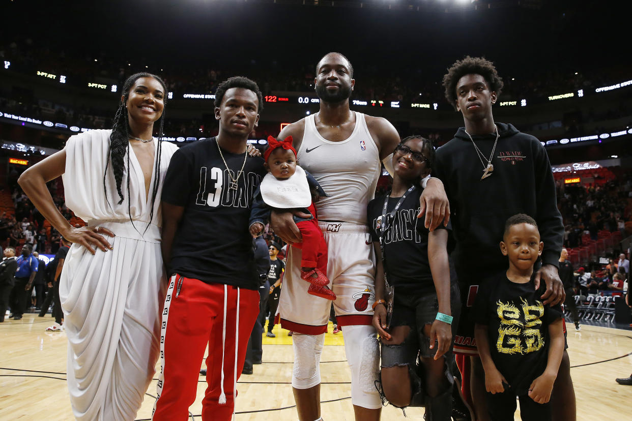 Dwyane Wade poses for a photo with his wife, Gabrielle Union, nephew, Dahveon Morris, and children, Kaavia James Union Wade, Zaire Wade, Xavier Wade and Zion (now Zaya) Wade after his final career home (Michael Reaves/Getty Images)