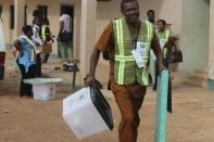 An official of the Independent National Electoral Commission arrives on March 28, 2015 with electoral material at a polling station in Abuja