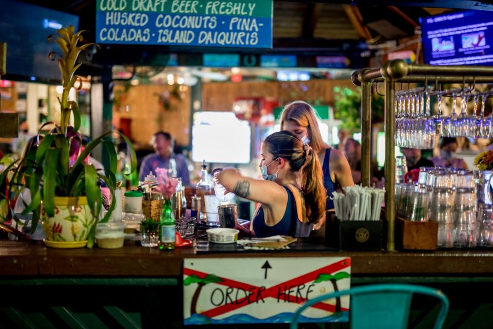 Bartenders prepare drinks at E.R. Bradley's in downtown West Palm Beach.