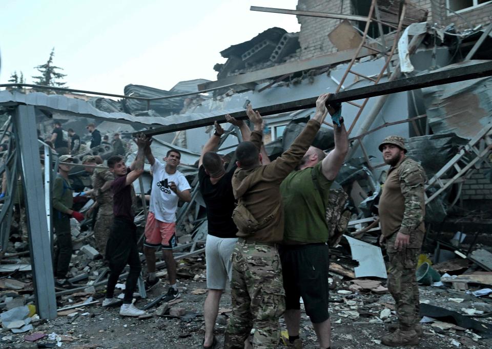 Rescuers and volunteers work to rescue people from under the rubble after a missile strike hit a restaurant in Kramatorsk, eastern Ukraine, on June 27, 2023. (Photo by Genya SAVILOV / AFP) (Photo by GENYA SAVILOV/AFP via Getty Images) ORIG FILE ID: AFP_33L88HJ.jpg
(Credit: GENYA SAVILOV, AFP via Getty Images)