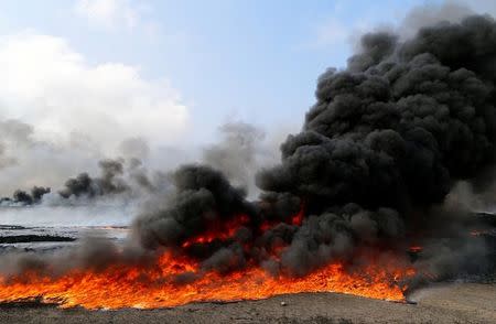 Oilfields burned by Islamic State fighters are seen in Qayyara, south of Mosul, Iraq December,21, 2016.REUTERS/Ammar Awad/Files