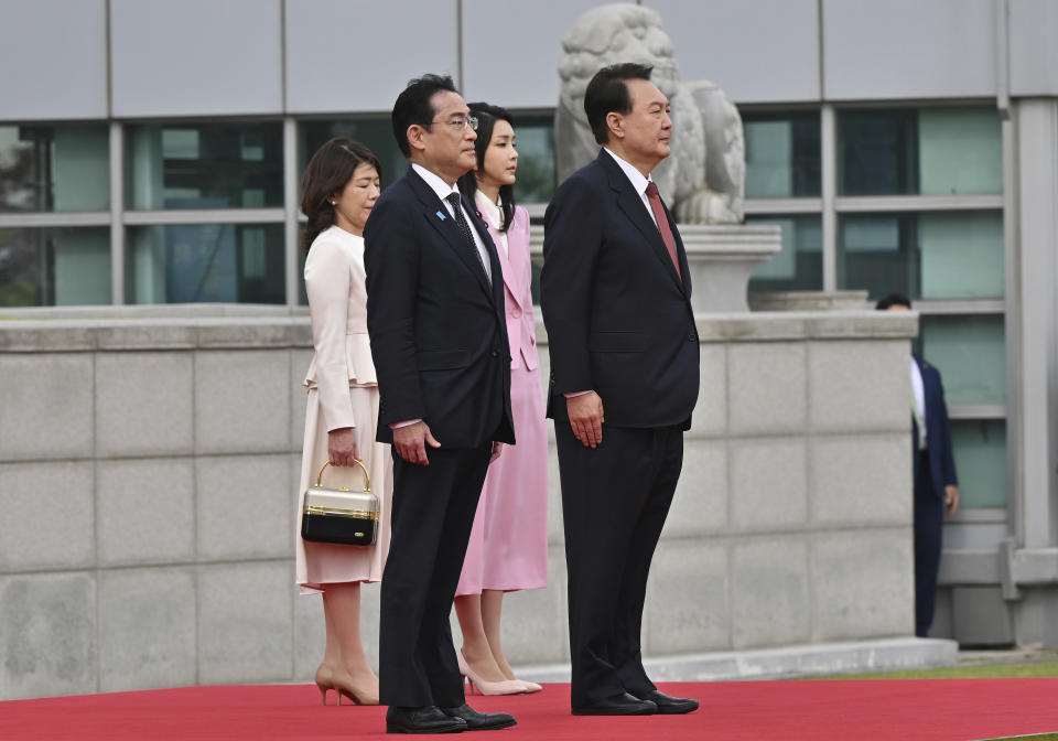 Japanese Prime Minister Fumio Kishida, second left, and his wife Yuko Kishida, left, attend with South Korean President Yoon Suk Yeol and his wife Kim Keon Hee during a welcoming ceremony at the presidential office in Seoul Sunday, May 7, 2023. (Jung Yeon-je/Pool Photo via AP)