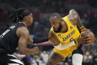 Los Angeles Lakers forward LeBron James, right, tries to get past Los Angeles Clippers guard Terance Mann during the first half of an NBA basketball game Wednesday, Nov. 9, 2022, in Los Angeles. (AP Photo/Mark J. Terrill)