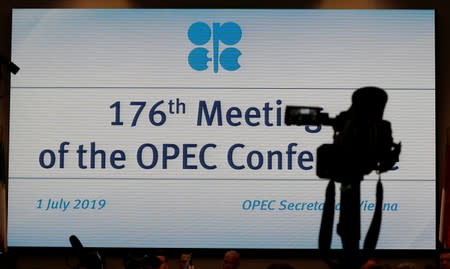 Journalists wait at the beginning of an OPEC meeting in Vienna