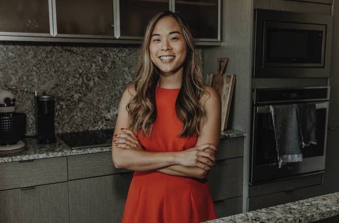 Lisa smiling and standing in a kitchen