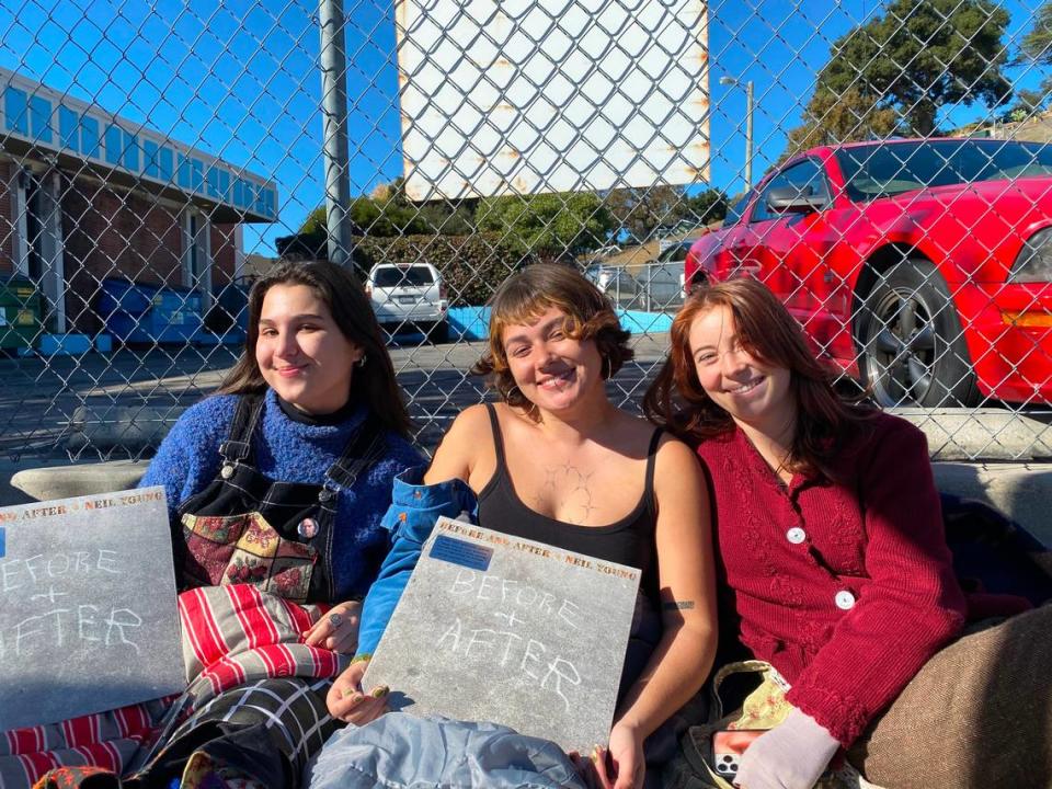 Touloula Ritter, Etta McCabe and Caroline Kraetzer camped out on Traffic Way in Atascadero in their sleeping bags to wait for an album signing with Neil Young on Friday, Dec. 8, 2023.