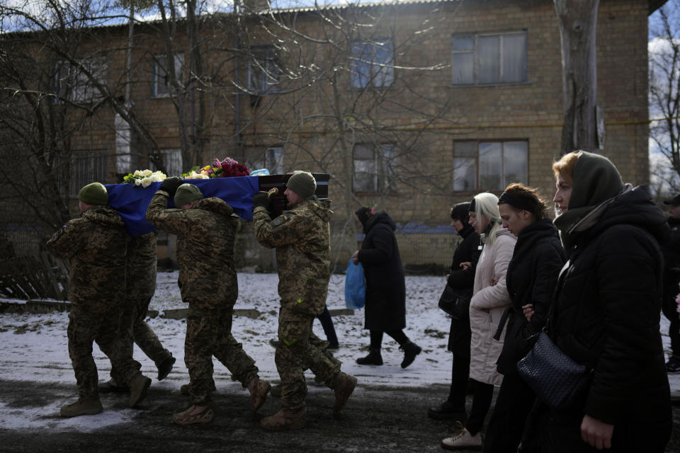 Soldiers carry the coffin of Vladyslav Bondarenko 26, during his funeral in Kozyntsi, near Kyiv, Ukraine, Monday, March 6, 2023. Bondarenko, a paratrooper of airmobile brigade, died near Bakhmut on Feb 26. (AP Photo/Thibault Camus)