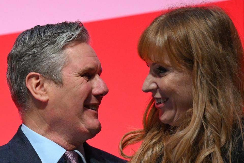 Britain's main opposition Labour Party leader Keir Starmer (L) prepares to embrace Britain's main opposition Labour Party deputy leader and Shadow Levelling Up, Housing and Communities Secretary Angela Rayner after her address to  delegates, on the first day of the annual Labour Party conference in Liverpool, north west England on October 8, 2023. (Photo by Oli SCARFF / AFP) (Photo by OLI SCARFF/AFP via Getty Images)