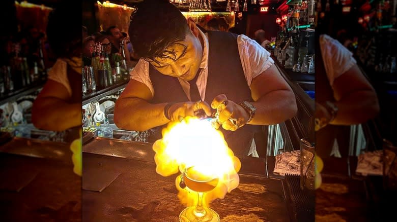 Bartender making flaming drink