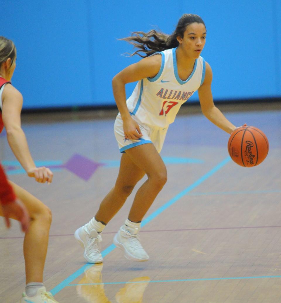 Alliance's Ella Smith handles the ball in the open court during an Eastern Buckeye Conference game against Salem at Alliance High School Wednesday, November 30, 2022.