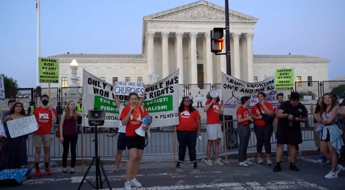 People protest outside the Supreme Court on Friday night (Julia Saqui/The Independent)