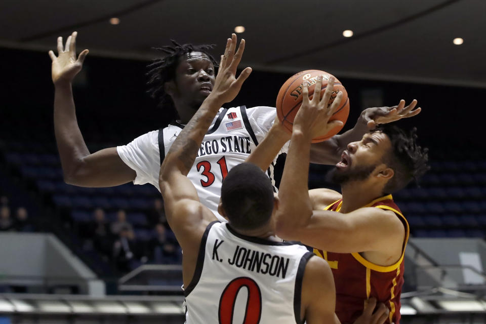 Southern California forward Isaiah Mobley, right, shoots against San Diego State forwards Nathan Mensah, top left, and Keshad Johnson during the first half of an NCAA college basketball game at the Wooden Legacy tournament in Anaheim, Calif., Friday, Nov. 26, 2021. (AP Photo/Alex Gallardo)