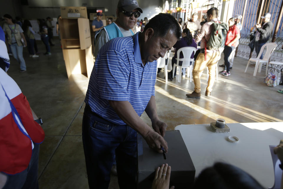 A man casts his vote during the presidential election at a polling station in San Salvador, El Salvador, Sunday, Feb. 3, 2019. Salvadorans are choosing from among a handful of presidential candidates all promising to end corruption, stamp out gang violence and create more jobs in the Central American nation. (AP Photo/Moises Castillo)