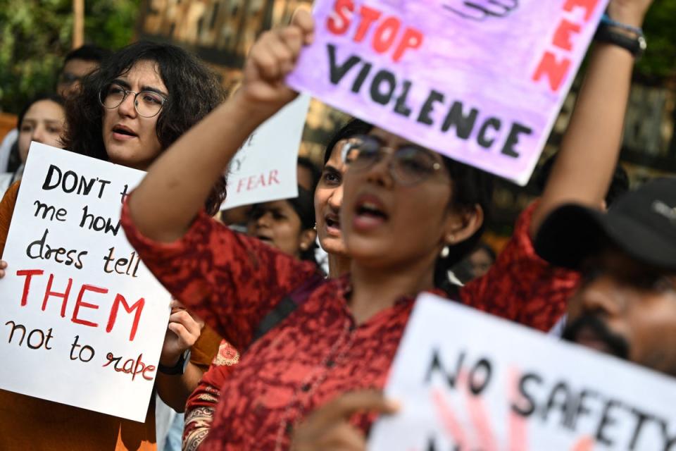 Medical professionals and students hold placards as they take part in a protest in New Delhi on 21 August 2024 (AFP via Getty Images)