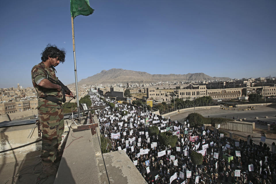 A soldier stands guard as Houthi supporters attend a demonstration against the United States over its decision to designate the Houthis a foreign terrorist organization in Sanaa, Yemen, Monday, Jan. 25, 2021. (AP Photo/Hani Mohammed)