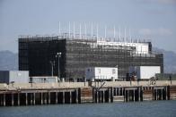 A barge built with four levels of shipping containers is seen at Pier 1 at Treasure Island in San Francisco, California in this file photo taken October 28, 2013. Google Inc's mysterious barges, which prompted fevered speculation about everything from offshore data centers to floating research labs, may serve a more prosaic role as upscale party venues and showrooms. REUTERS/Stephen Lam/Files (UNITED STATES - Tags: SCIENCE TECHNOLOGY BUSINESS)