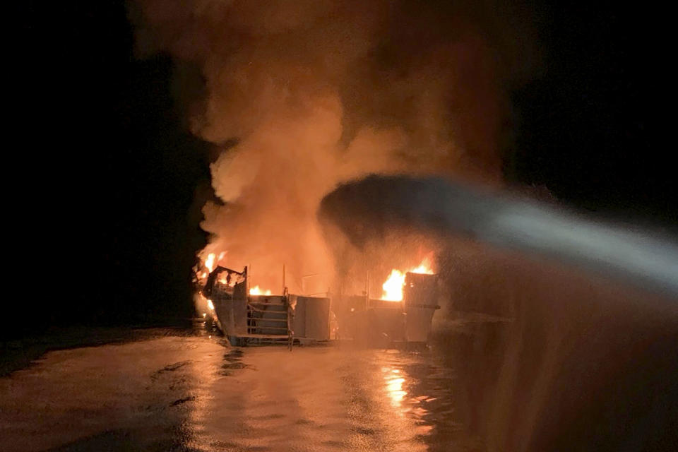 FILE - In this Sept. 2, 2019, file photo provided by the Ventura County Fire Department, VCFD firefighters respond to a fire aboard the Conception dive boat fire in the Santa Barbara Channel off the coast of Southern California. Coroner's reports for the 34 victims who died in the massive scuba boat fire off the Southern California coast last year show the divers died of carbon monoxide poisoning before they were burned, authorities said Thursday, May 21, 2020. (Ventura County Fire Department via AP, File)