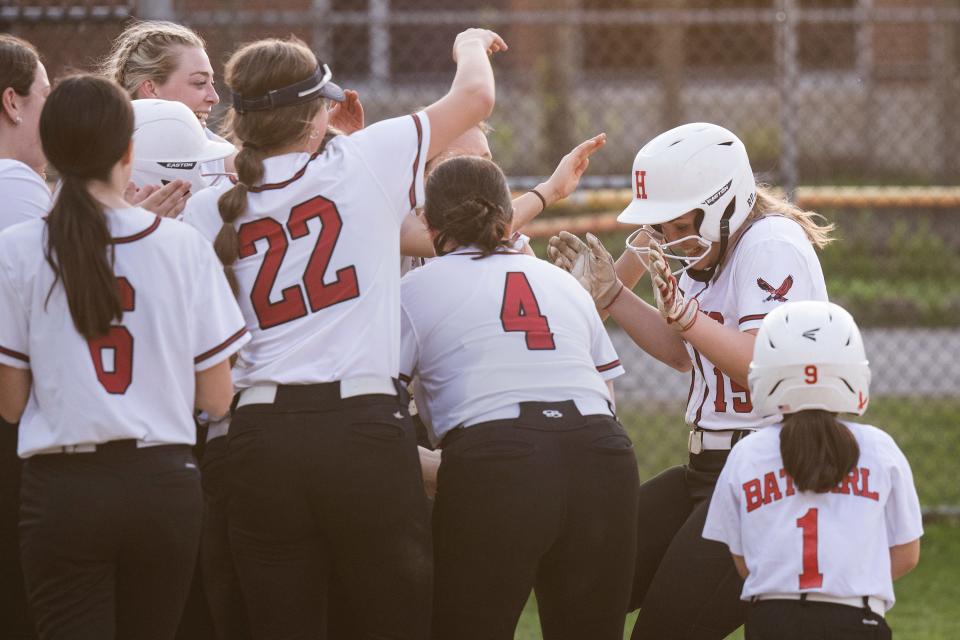 Hudson's Lauren O'Malley, far right, is congratulated by the team after hitting a homer against Clinton on Monday.