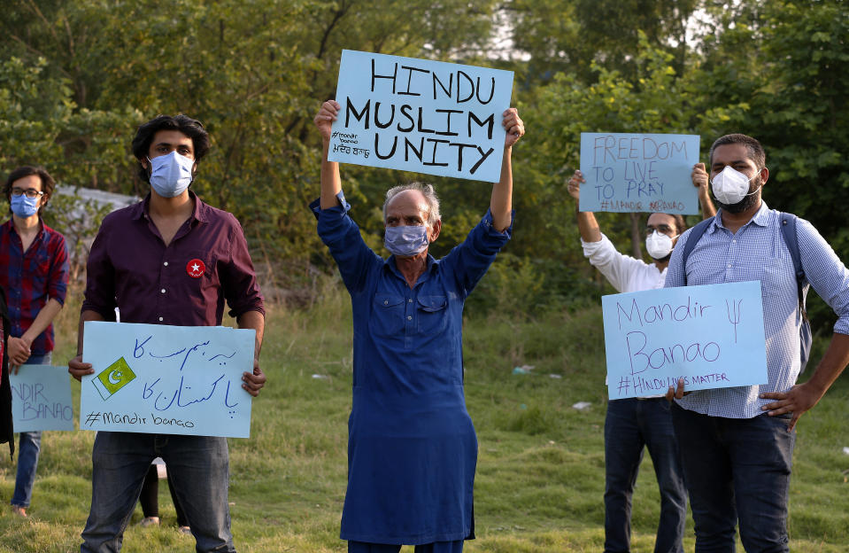 Members of a civil society group hold a demonstration demanding the government allow the construction of a Hindu temple, in Islamabad, Pakistan, Wednesday, July 8, 2020. A senior political figure, allied with the government and backed by Islamic extremists, stopped the construction of the temple. Analysts and activists say minorities in Pakistan are increasingly vulnerable to Islamic extremists as Prime Minister Imran Khan vacillates between trying to forge a pluralistic nation and his conservative Islamic beliefs. (AP Photo/Anjum Naveed)