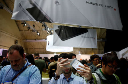 A man takes pictures of Huawei's new P10 Plus device after its presentation ceremony at Mobile World Congress in Barcelona, Spain, February 26, 2017. REUTERS/Paul Hanna/File Photo