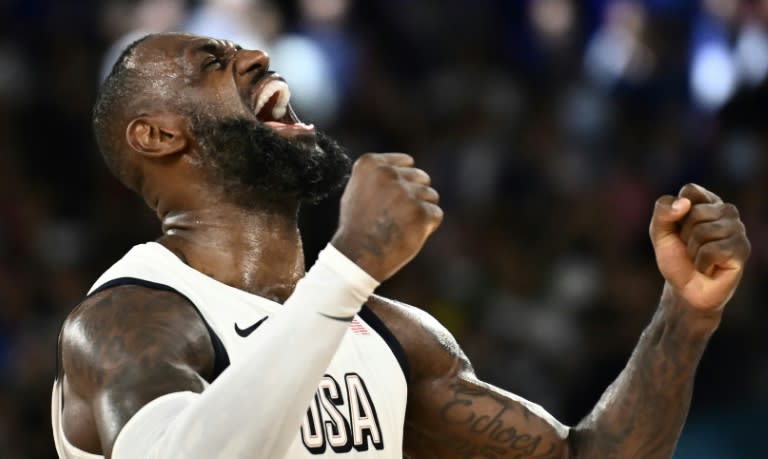 LeBron James roars with delight after the US chased down Serbia to reach the Olympic men's basketball final (Aris MESSINIS)