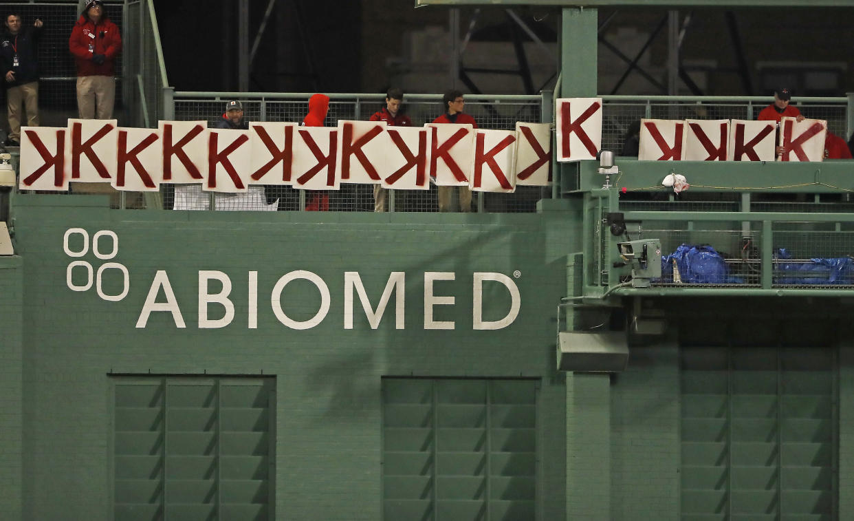 A fan, right, records the 17th strikeout of Boston Red Sox's Chris Sale during the seventh inning of a baseball game against the Colorado Rockies Tuesday, May 14, 2019, at Fenway Park in Boston. (AP Photo/Winslow Townson)