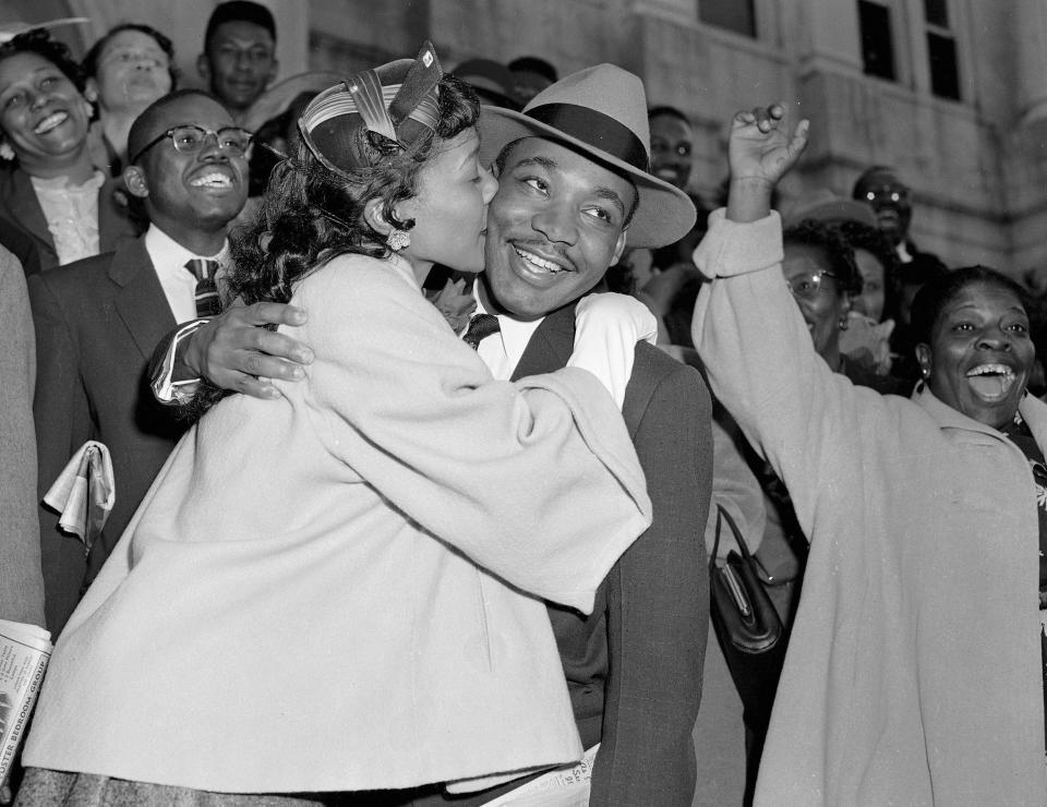 The Rev. Martin Luther King Jr. is welcomed with a kiss by his wife Coretta Scott King after leaving court in Montgomery in a file photo from March 22, 1956.