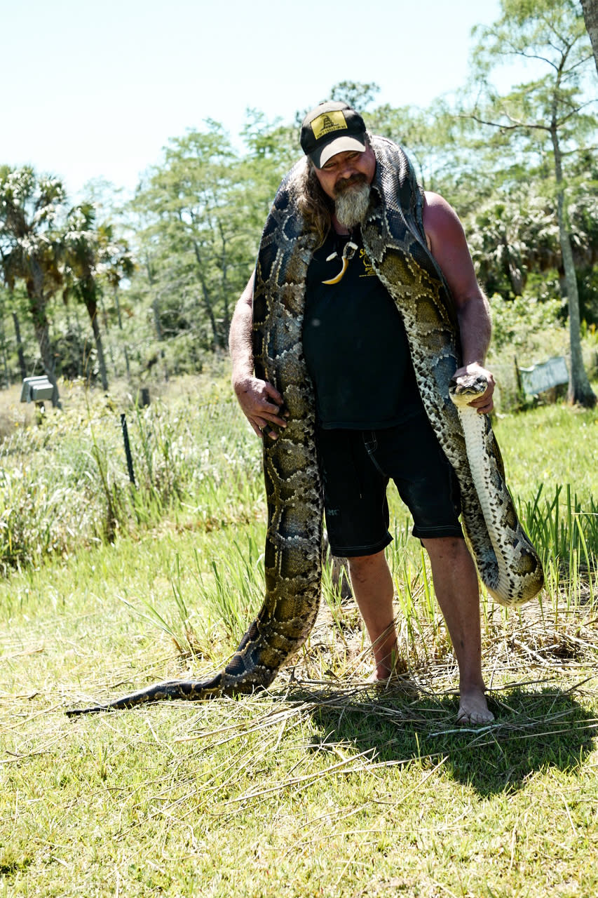 Dusty Crum holds a snake in Florida in 2017. (Courtesy Lisette Morales McCabe)