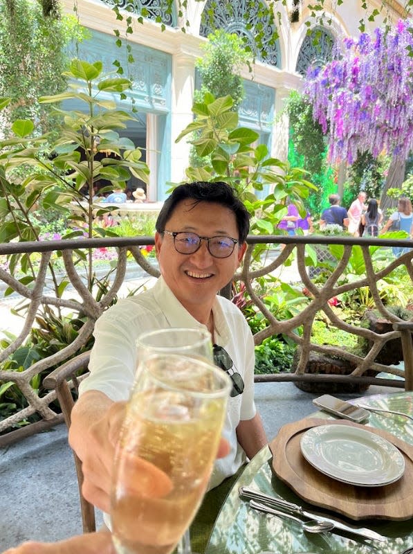 wendy lee husband cheersing with champagne at bellagio