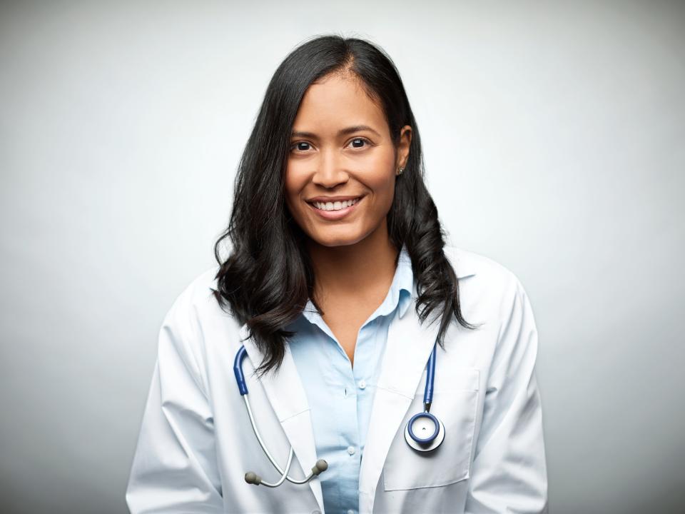 A stock photo of a female doctor of color.