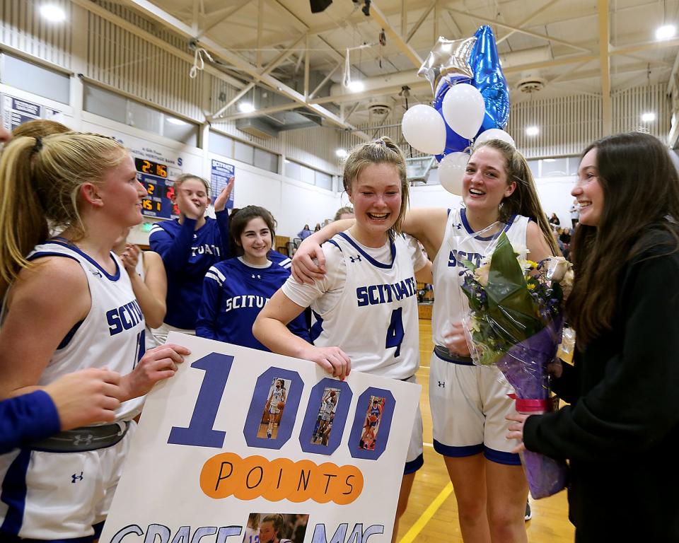 Scituate's Grace McNamara is hugged by Scituate's Grace Love after she scored her 1000th point in the second quarter of their game against Pembroke at Scituate High on Friday, Jan. 27, 2023. 