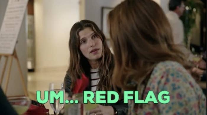 A woman looking at another woman with the words, "um...red flag"