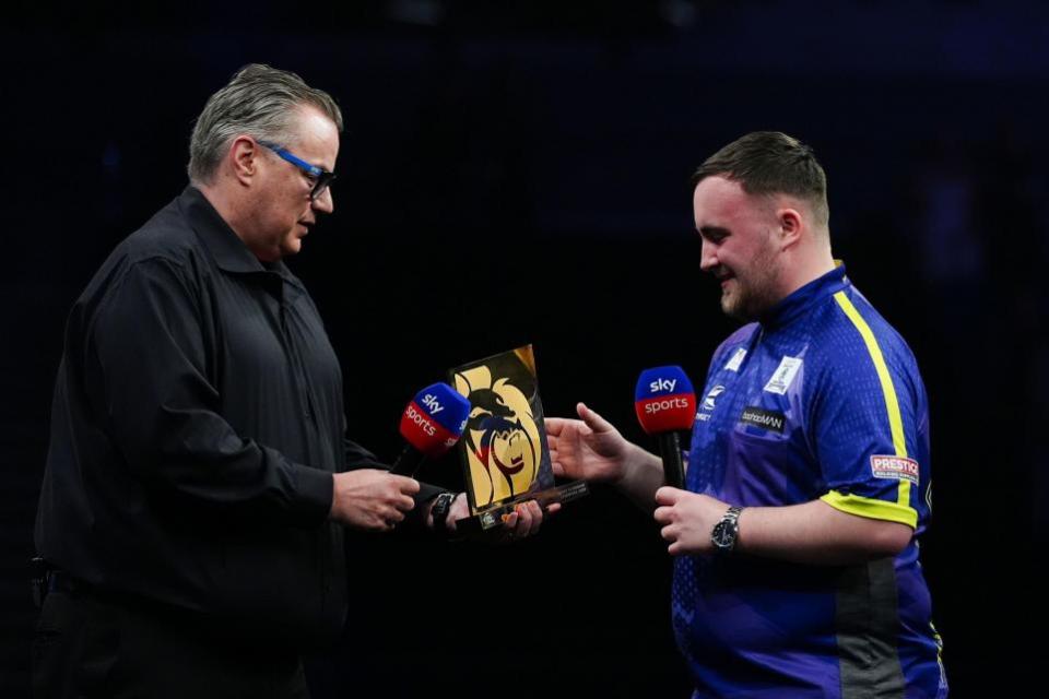 Warrington Guardian: Littler is presented with the Night 13 trophy by former world champion John Part
