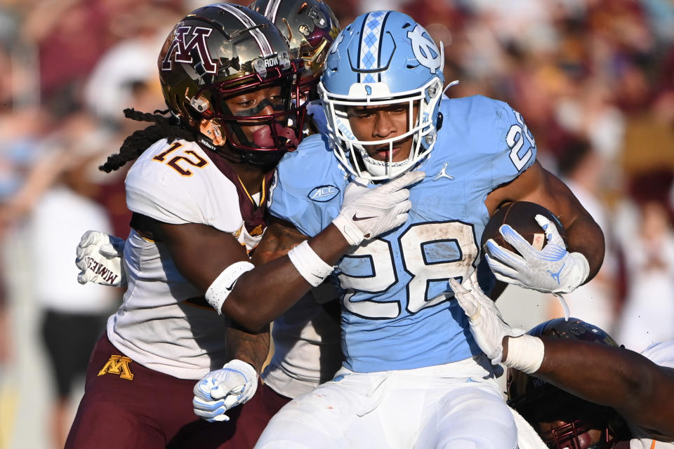 Sep 16, 2023; Chapel Hill, North Carolina, USA; North Carolina Tar Heels running back Omarion Hampton (28) with the ball as Minnesota Golden Gophers defensive back Darius Green (12) defends in the fourth quarter at Kenan Memorial Stadium. Mandatory Credit: Bob Donnan-USA TODAY Sports