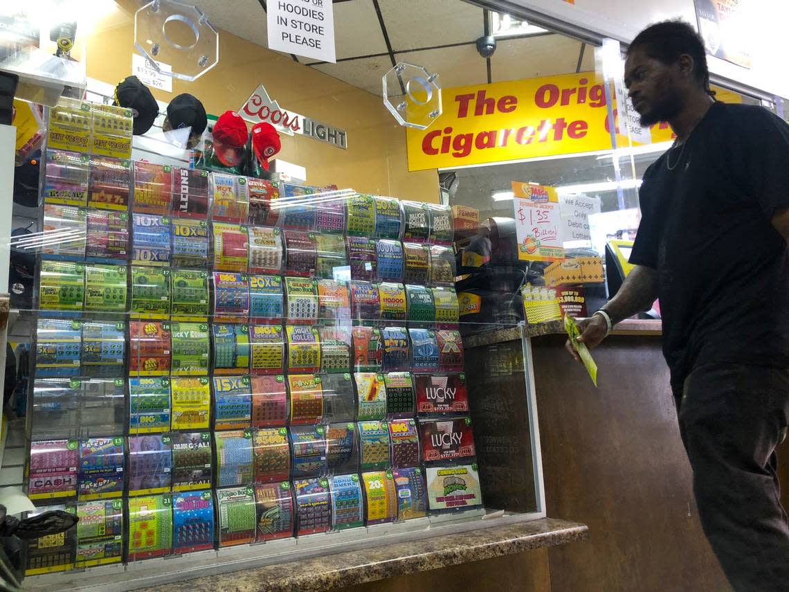 A customer eyes the scratch-off lottery selections at the LoLo Food Mart at the corner of Pio Nono Avenue and Eisenhower Parkway in Macon, Georgia. The store is the leading seller of lottery tickets in Bibb County.