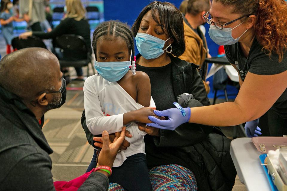 Amaya Marshall's parents, Randy and Nooriya Marshall, as well as COPC employee Heather Hendrickson comforted Amaya before receiving a Pfizer vaccine dose at Central Ohio Primary Care in Westerville on Saturday.