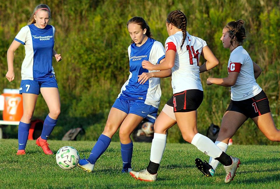 Northwestern High School’s Florida Blake (11) works the ball to the middle of the field against Crestview High School’s Nicole Fulk (1) and Mary Leeper (14) during high school girls soccer action at Northwestern on Thursday, Sept. 3, 2020. Tom E. Puskar, Times-Gazette.com