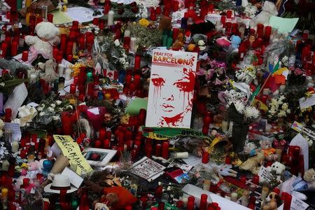 A placard reading "Pray for Barcelona" is seen at an impromptu memorial where a van crashed into pedestrians at Las Ramblas in Barcelona, Spain, August 19, 2017. REUTERS/Susana Vera