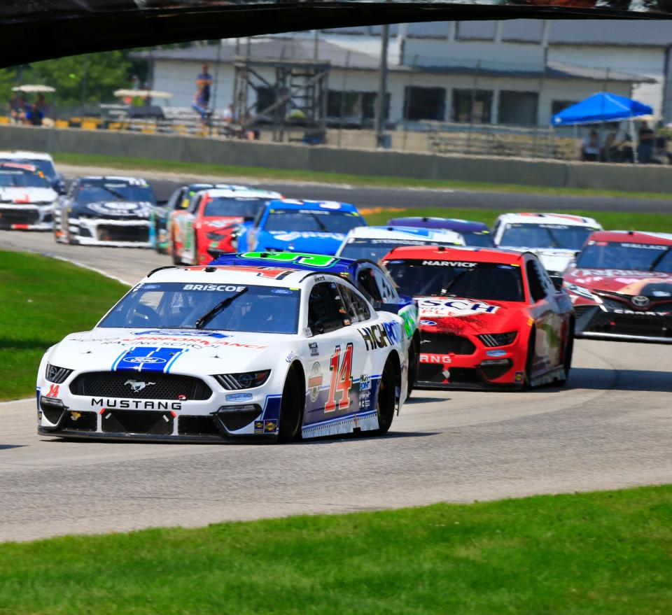 Mitchell's Chase Briscoe leads a long line of cars at Road America earlier this season. The NASCAR Cup Series is back on a road course Sunday at Indianapolis Motor Speedway.