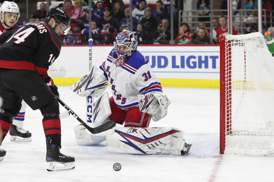 New York Rangers goaltender Igor Shesterkin (31), of Russia, defends the goal against Carolina Hurricanes right wing Justin Williams (14) during the second period of an NHL hockey game in Raleigh, N.C., Friday, Feb. 21, 2020. (AP Photo/Gerry Broome)